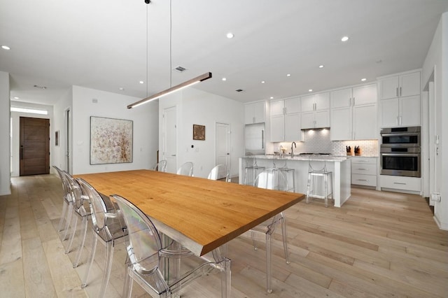 2608 Watkins Way, Austin, TX 78746 - dining area with light wood-style floors and recessed lighting