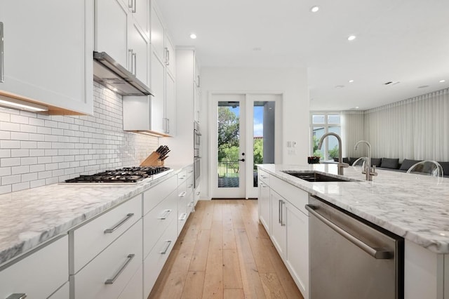 2608 Watkins Way, Austin, TX 78746 - kitchen featuring appliances with stainless steel finishes, white cabinets, recessed lighting, ventilation hood, and tasteful backsplash