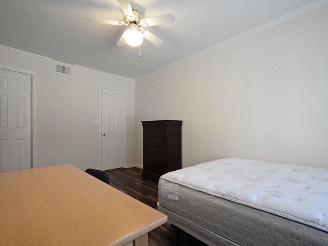 501 W 26th St Unit 102, Austin, TX 78705 - bedroom with dark wood finished floors, crown molding, and ceiling fan