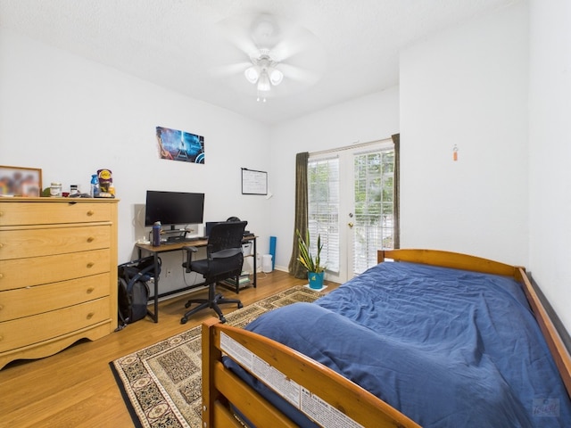 3111 Tom Green St Unit 208, Austin, TX 78705 - bedroom featuring access to outside, light wood-style floors, and a ceiling fan