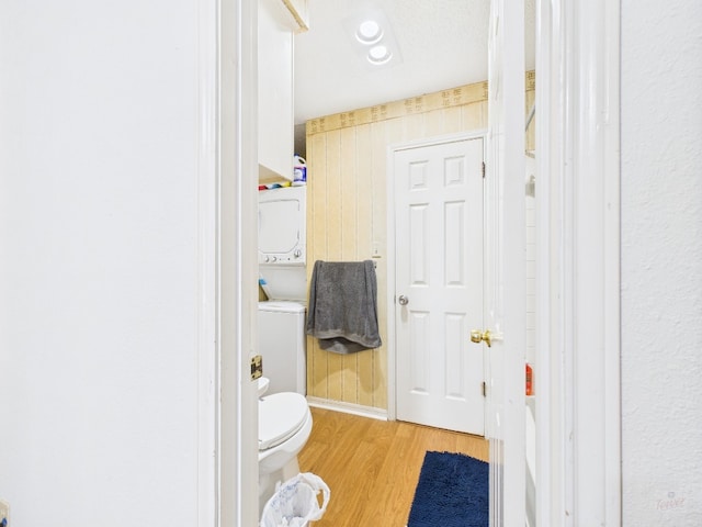 3111 Tom Green St Unit 208, Austin, TX 78705 - bathroom with stacked washing machine and dryer and wood finished floors