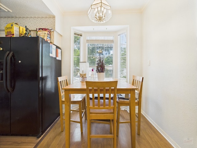 3111 Tom Green St Unit 208, Austin, TX 78705 - dining area with wood finished floors, a chandelier, and crown molding