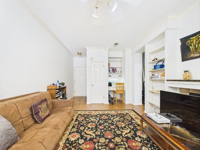 3111 Tom Green St Unit 208, Austin, TX 78705 - living room featuring crown molding, wood finished floors, and built in shelves