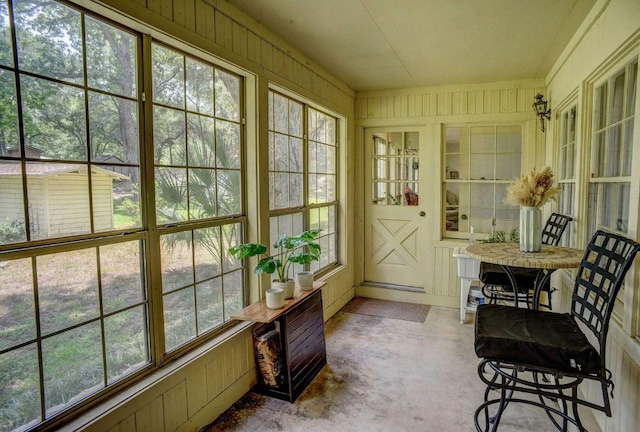4703 Laguna Ln, Austin, TX 78746 - sunroom / solarium featuring wood walls and concrete floors