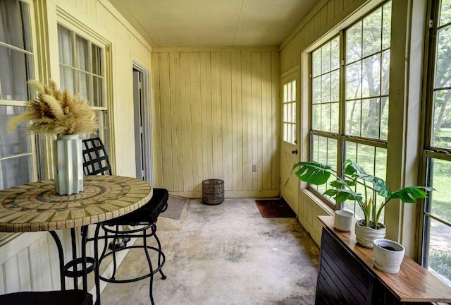 4703 Laguna Ln, Austin, TX 78746 - sunroom / solarium featuring unfinished concrete flooring and wooden walls