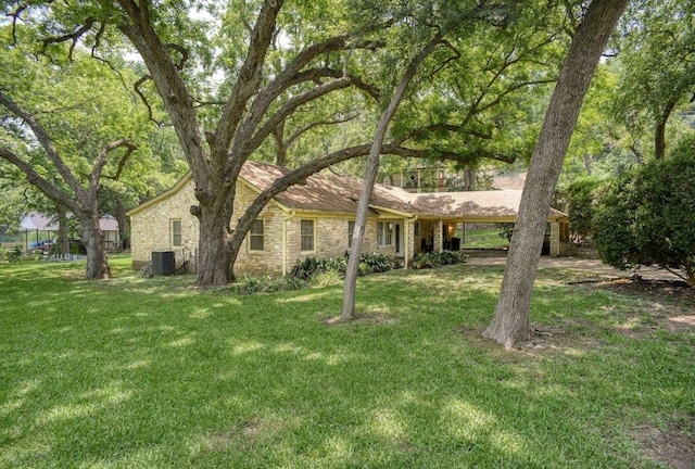 4703 Laguna Ln, Austin, TX 78746 - view of front of house featuring a front yard, stone siding, and an attached carport