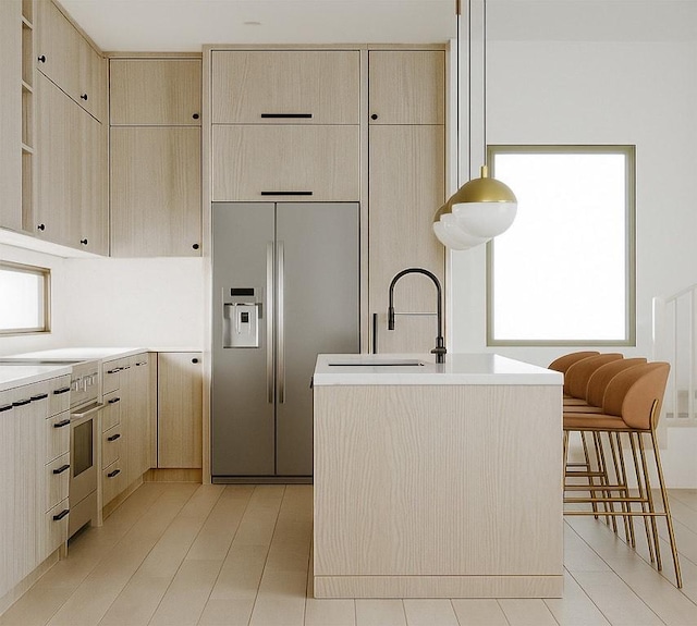 1208 Karen Ave Unit 3, Austin, TX 78757 - kitchen featuring stainless steel fridge, light brown cabinetry, light countertops, cream cabinetry, and a kitchen island with sink