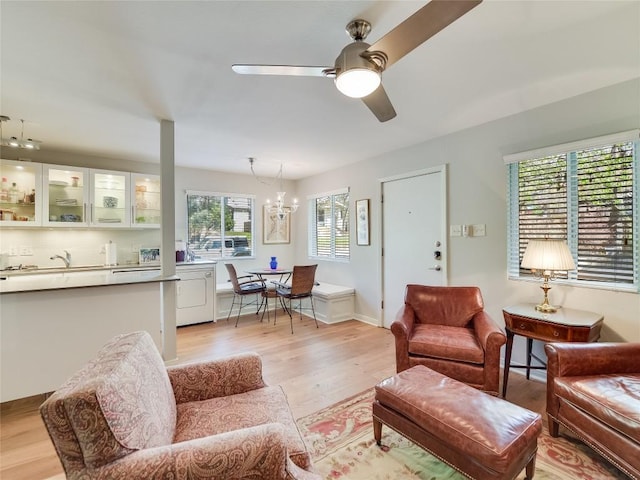 1503 W 9th St Unit 106, Austin, TX 78703 - living area with light wood-style flooring, ceiling fan, and a chandelier