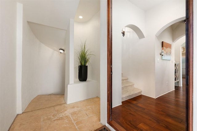 1404 Hurst Creek Rd, Austin, TX 78734 - hall with arched walkways, wood finished floors, stairway, and recessed lighting