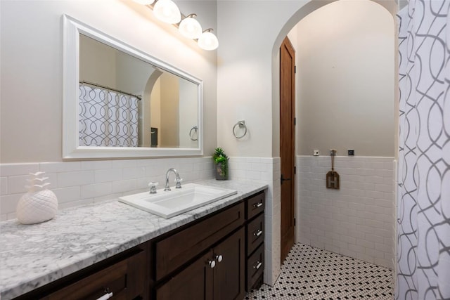 1404 Hurst Creek Rd, Austin, TX 78734 - bathroom featuring vanity, tile walls, and wainscoting