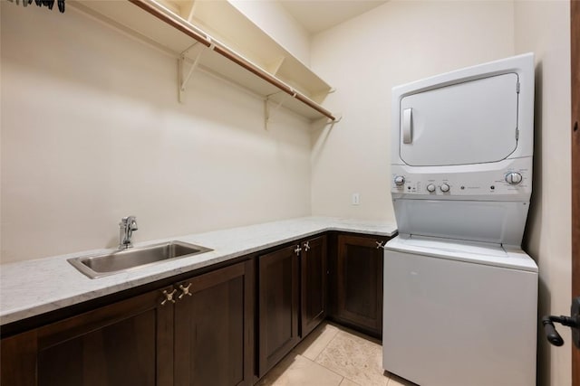 1404 Hurst Creek Rd, Austin, TX 78734 - washroom featuring stacked washer and clothes dryer, cabinet space, and light tile patterned floors