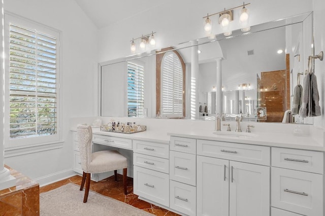 11208 Woodland Hills Trl, Austin, TX 78732 - full bathroom with vanity, vaulted ceiling, a shower, and decorative columns
