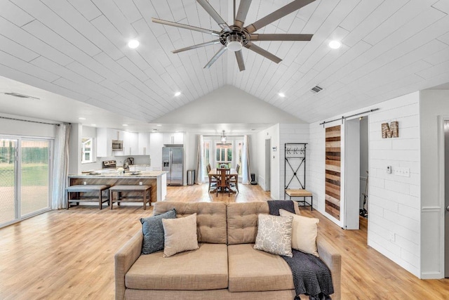 3705 Peach Vista Dr, Pflugerville, TX 78660 - living room featuring a barn door, a ceiling fan, light wood-style floors, lofted ceiling, and recessed lighting