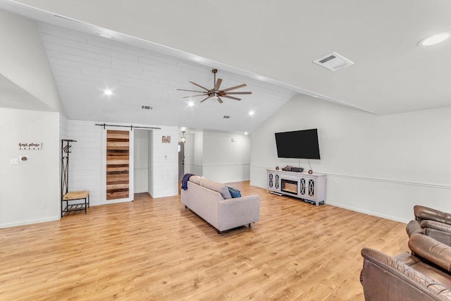 3705 Peach Vista Dr, Pflugerville, TX 78660 - living area with lofted ceiling, light wood finished floors, a ceiling fan, a barn door, and recessed lighting