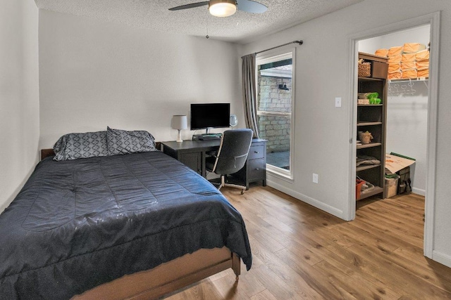 3705 Peach Vista Dr, Pflugerville, TX 78660 - bedroom with a textured ceiling, wood finished floors, a spacious closet, ceiling fan, and an office area