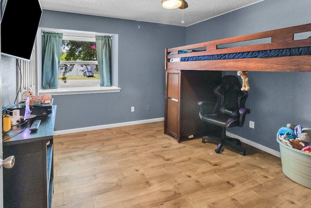 3705 Peach Vista Dr, Pflugerville, TX 78660 - bedroom with light wood-style floors and a textured ceiling
