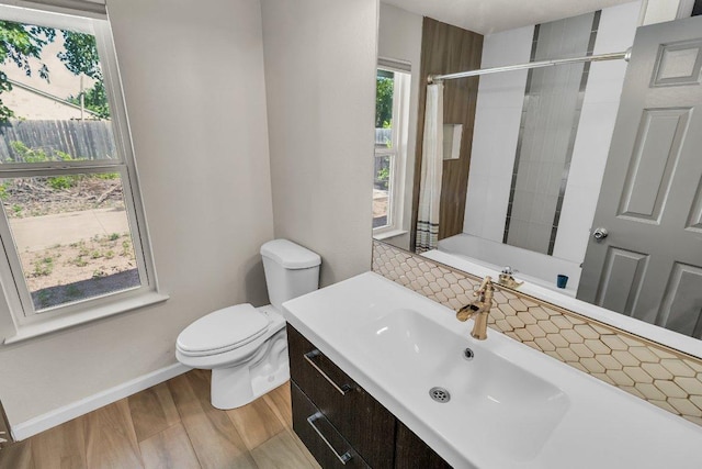 3705 Peach Vista Dr, Pflugerville, TX 78660 - bathroom featuring wood finished floors, backsplash, and vanity