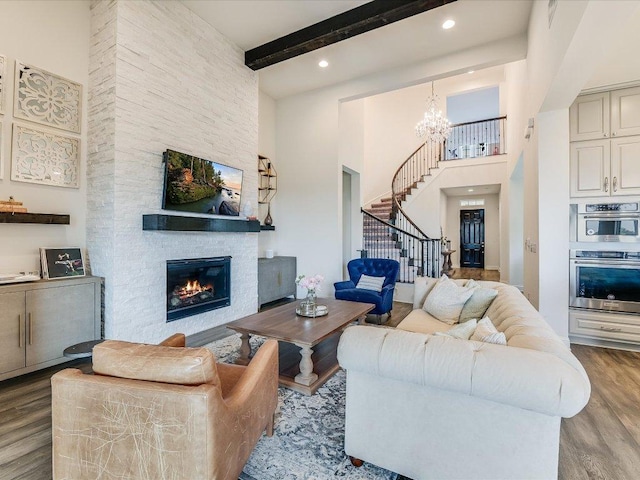 6701 Denia Dr, Austin, TX 78739 - living area featuring stairway, wood finished floors, a chandelier, beamed ceiling, and a high ceiling