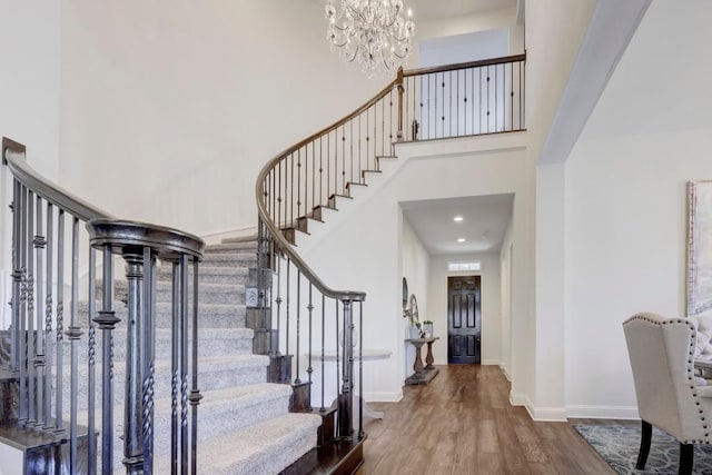 6701 Denia Dr, Austin, TX 78739 - entrance foyer featuring stairs, wood finished floors, a chandelier, and a towering ceiling