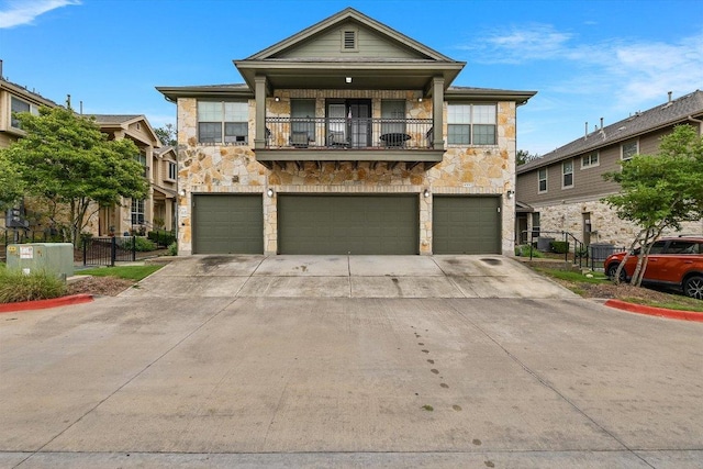 3101 Davis Ln Unit 6503, Austin, TX 78748 - view of front of property with stone siding, a balcony, and a garage