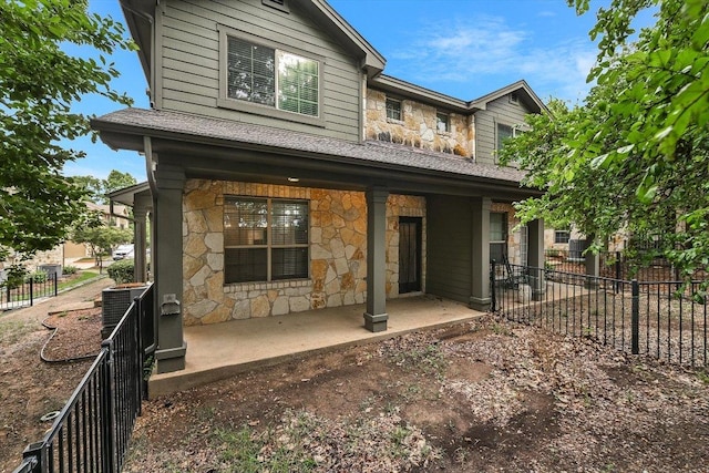 3101 Davis Ln Unit 6503, Austin, TX 78748 - rear view of property with stone siding and roof with shingles