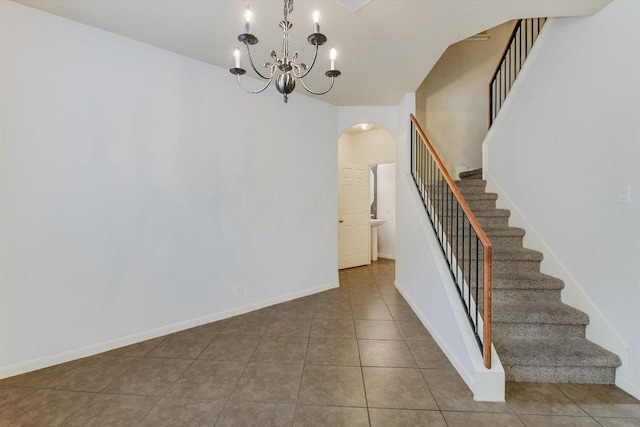 3101 Davis Ln Unit 6503, Austin, TX 78748 - staircase featuring arched walkways, a chandelier, and tile patterned floors