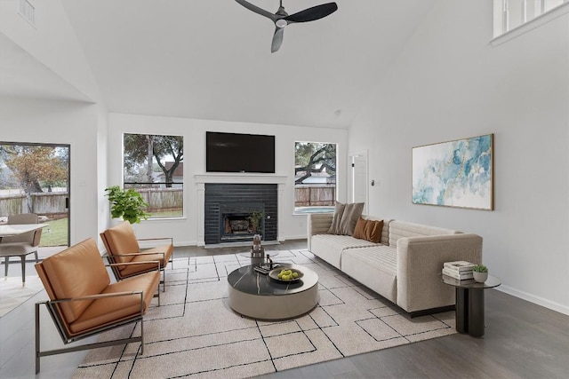 7401 Whistlestop Dr, Austin, TX 78749 - living area featuring high vaulted ceiling, a ceiling fan, a tiled fireplace, and wood finished floors