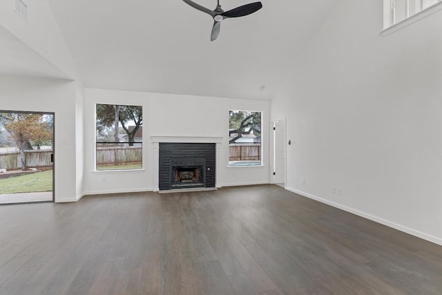 7401 Whistlestop Dr, Austin, TX 78749 - unfurnished living room featuring ceiling fan, a fireplace, dark wood-type flooring, and high vaulted ceiling