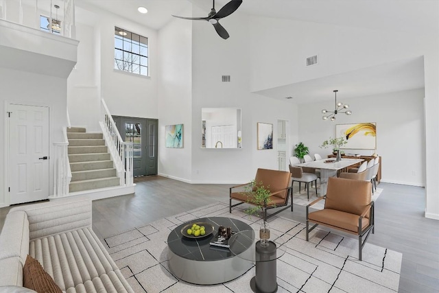 7401 Whistlestop Dr, Austin, TX 78749 - living area featuring stairs, a high ceiling, wood finished floors, a chandelier, and ceiling fan