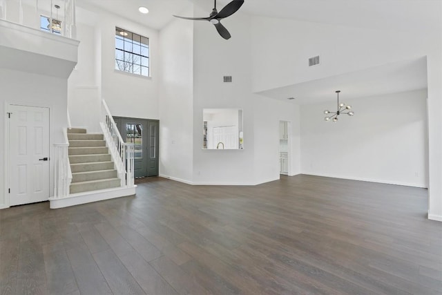 7401 Whistlestop Dr, Austin, TX 78749 - unfurnished living room with stairs, a chandelier, dark wood finished floors, a high ceiling, and ceiling fan
