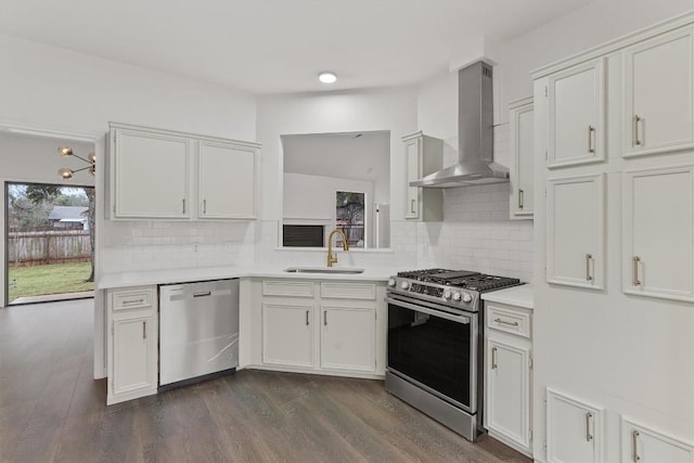7401 Whistlestop Dr, Austin, TX 78749 - kitchen with stainless steel appliances, wall chimney exhaust hood, light countertops, and backsplash