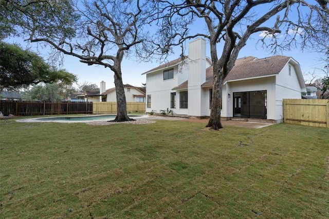 7401 Whistlestop Dr, Austin, TX 78749 - back of property with a fenced backyard, a chimney, and roof with shingles