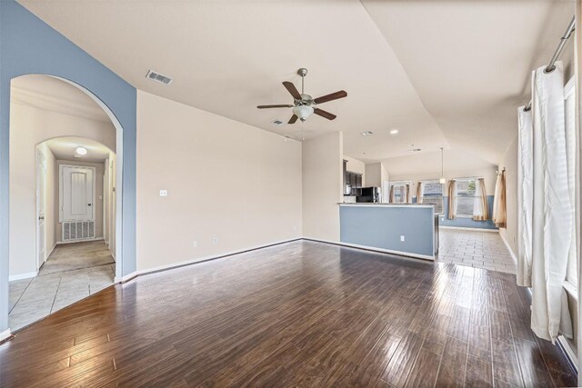 4019 Brookhaven Dr, Temple, TX 76504 - unfurnished living room featuring a ceiling fan, wood finished floors, and arched walkways