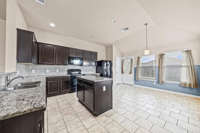 4019 Brookhaven Dr, Temple, TX 76504 - kitchen featuring black appliances, vaulted ceiling, tasteful backsplash, a center island, and light stone counters