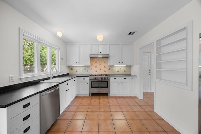 1807 W Saint Johns Ave, Austin, TX 78757 - kitchen with appliances with stainless steel finishes, under cabinet range hood, and dark countertops
