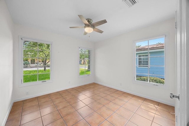 1807 W Saint Johns Ave, Austin, TX 78757 - empty room featuring healthy amount of natural light, a ceiling fan, and light tile patterned floors