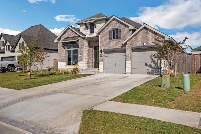 14521 Kira Ln, Manor, TX 78653 - view of front facade featuring concrete driveway, brick siding, roof with shingles, and stone siding