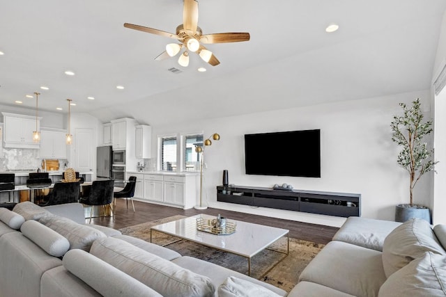 14521 Kira Ln, Manor, TX 78653 - living area with dark wood-style floors, recessed lighting, ceiling fan, and vaulted ceiling
