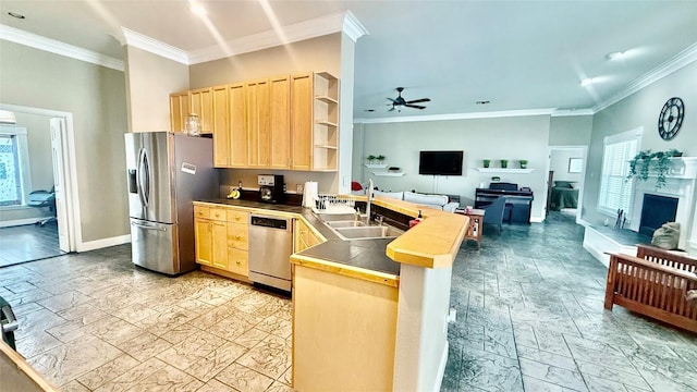 1127 Robin Rd, Elgin, TX 78621 - kitchen with appliances with stainless steel finishes, a peninsula, light brown cabinets, open floor plan, and crown molding