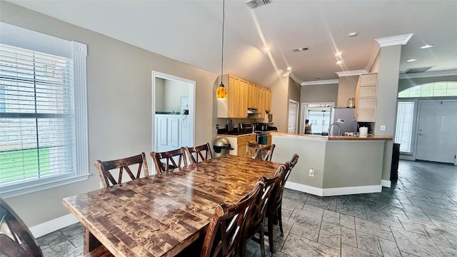 1127 Robin Rd, Elgin, TX 78621 - dining space featuring healthy amount of natural light, ornamental molding, and stone tile floors