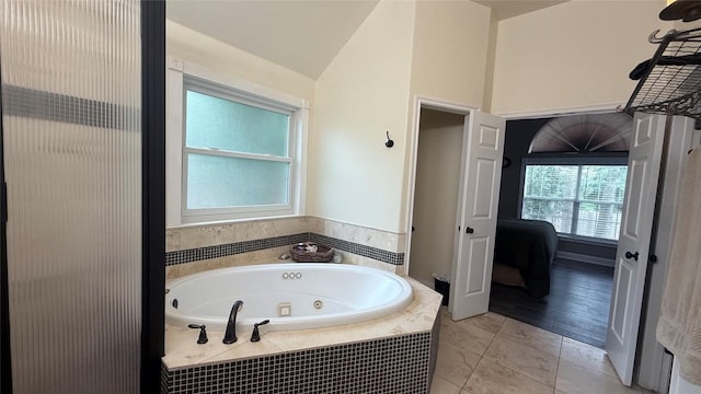 1127 Robin Rd, Elgin, TX 78621 - full bathroom with a tub with jets and vaulted ceiling