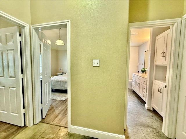 1127 Robin Rd, Elgin, TX 78621 - hallway featuring a textured wall and baseboards