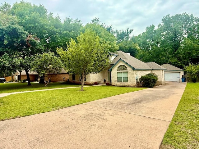 1127 Robin Rd, Elgin, TX 78621 - view of front of house with stone siding, a front yard, and a garage