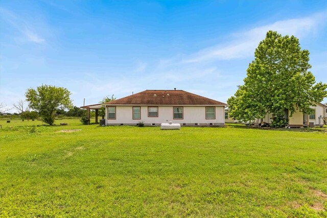 12212 Ballerstedt Rd, Elgin, TX 78621 - back of house with a yard