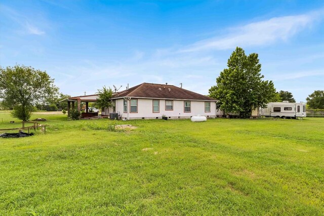 12212 Ballerstedt Rd, Elgin, TX 78621 - back of house with a lawn