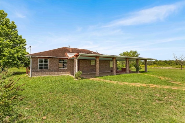 12212 Ballerstedt Rd, Elgin, TX 78621 - rear view of property with a yard and brick siding