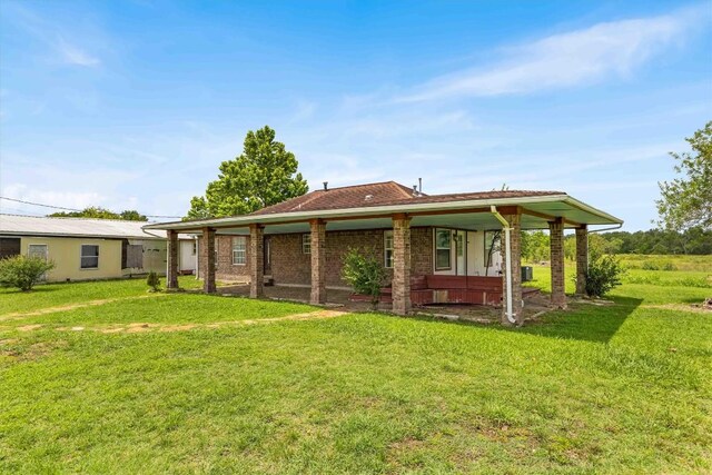 12212 Ballerstedt Rd, Elgin, TX 78621 - back of house with a lawn