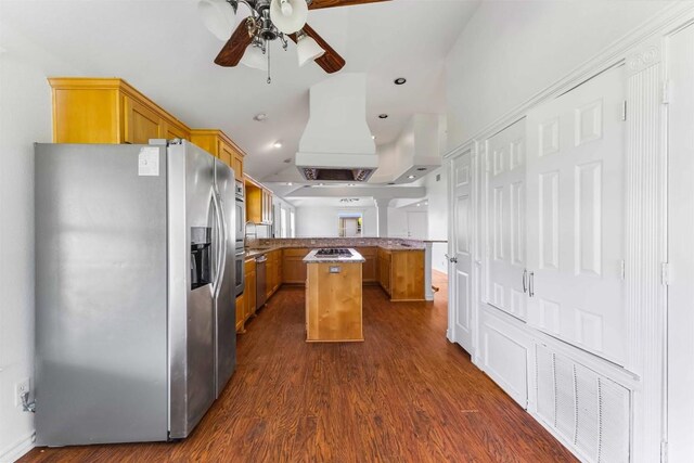 12212 Ballerstedt Rd, Elgin, TX 78621 - kitchen featuring appliances with stainless steel finishes, a peninsula, a center island, ceiling fan, and dark wood-type flooring
