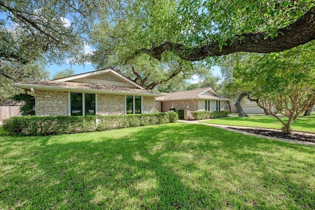 10507 Spicewood Pkwy, Austin, TX 78750 - ranch-style home with a front lawn and stone siding