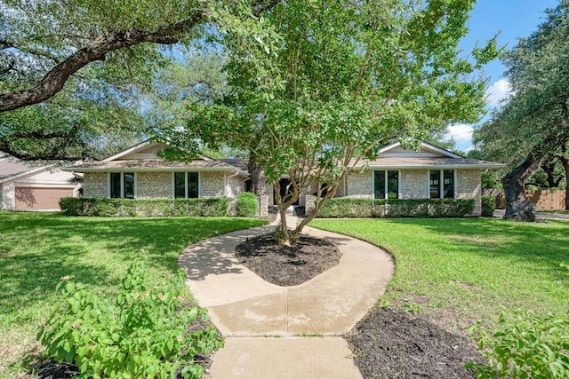 10507 Spicewood Pkwy, Austin, TX 78750 - ranch-style home featuring a front yard and brick siding